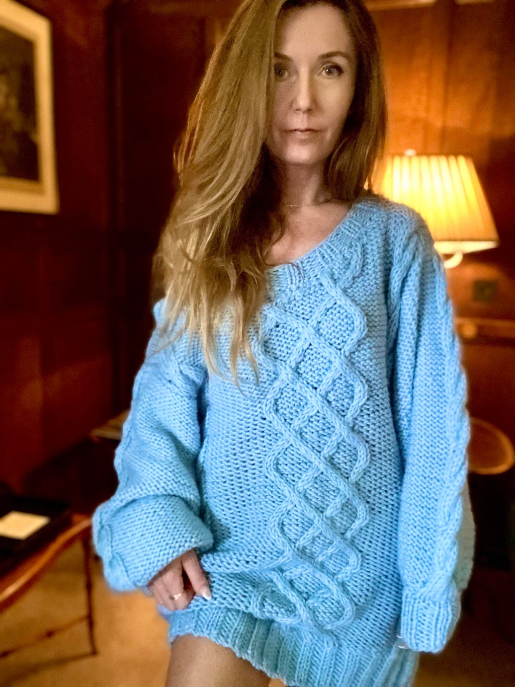 Hand-knitted wool sweater dress: light blue, oversized, with a cable-knit pattern.