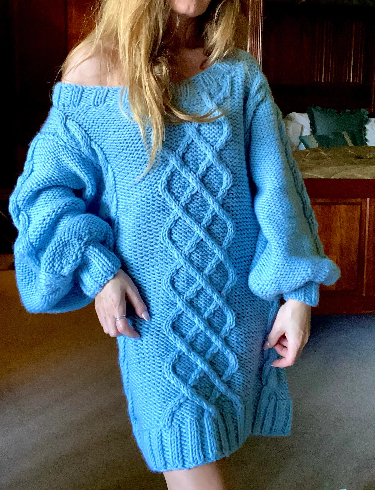 Hand-knitted wool sweater dress: light blue, oversized, with a cable-knit pattern.