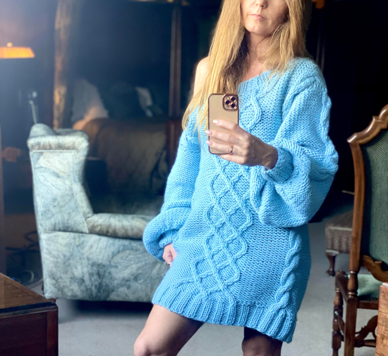 Hand-knitted wool sweater dress: light blue, oversized, with a cable-knit pattern.