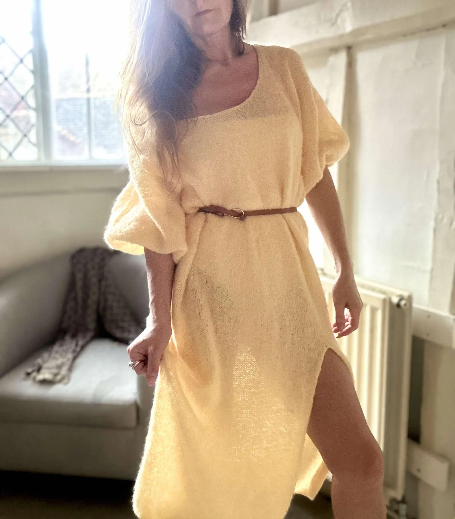 Hand-knitted alpaca midi dress with an off-the-shoulder neckline and a side slit; fits sizes XS–M.