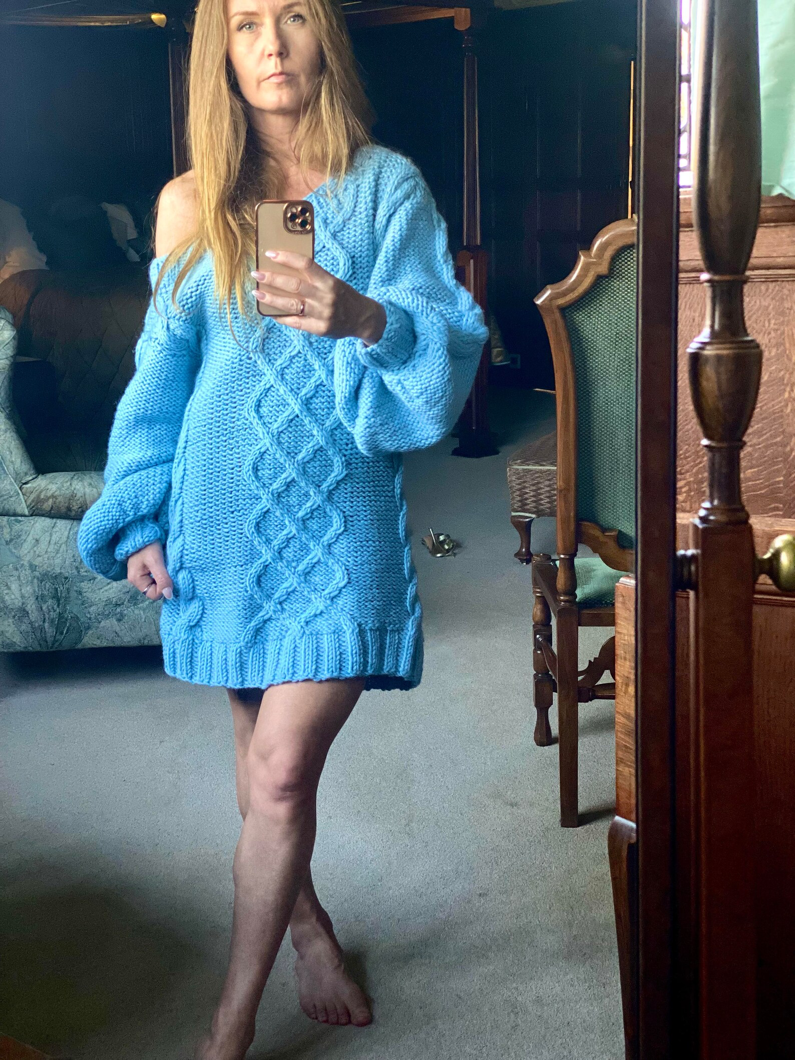 Hand-knitted wool sweater dress: light blue, oversized, with a cable-knit pattern.