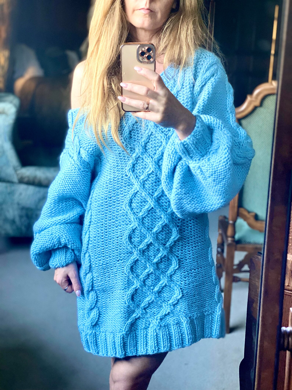 Hand-knitted wool sweater dress: light blue, oversized, with a cable-knit pattern.