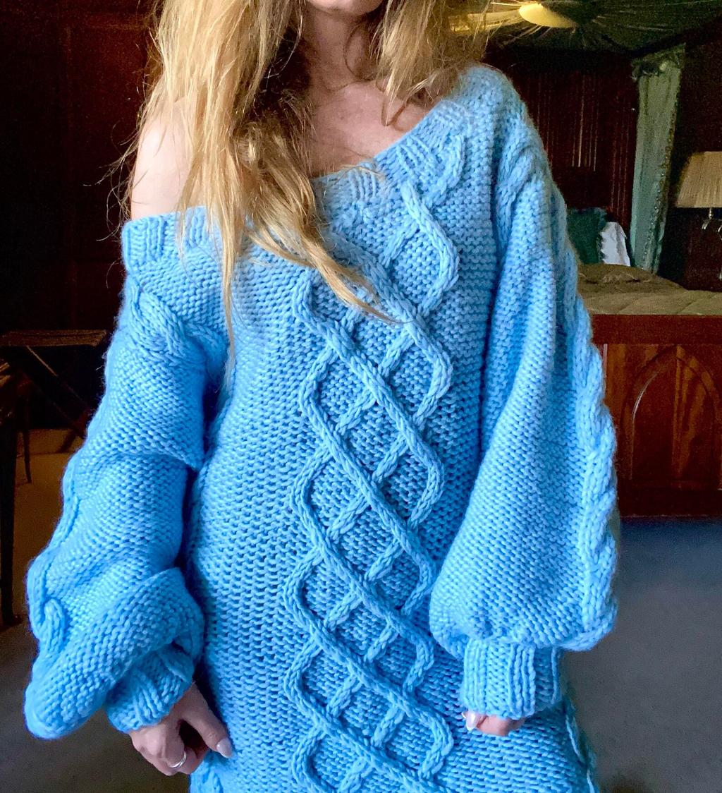 Hand-knitted wool sweater dress: light blue, oversized, with a cable-knit pattern.
